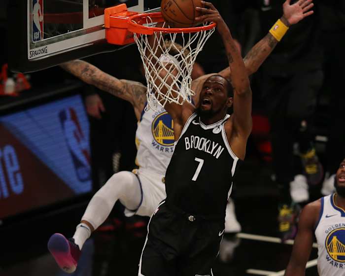 Brooklyn Nets forward Kevin Durant dunks against Golden State Warriors forward Kelly Oubre Jr. during the first quarter at Barclays Center.